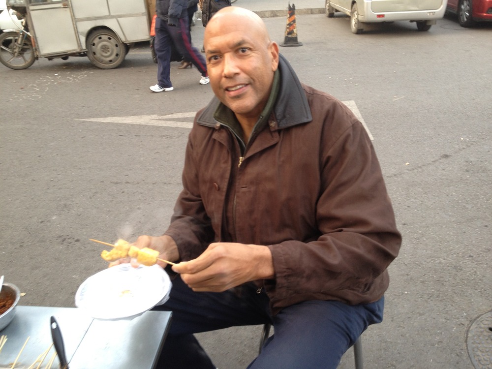 James_trying_out_some_chinese_street_food_-_2012