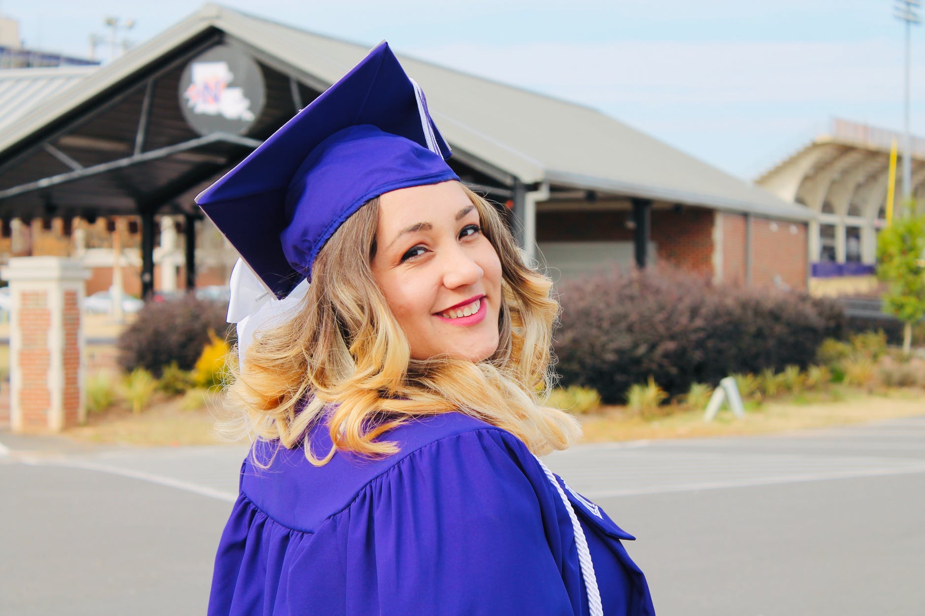 woman wearing purple mortar board and academic robe