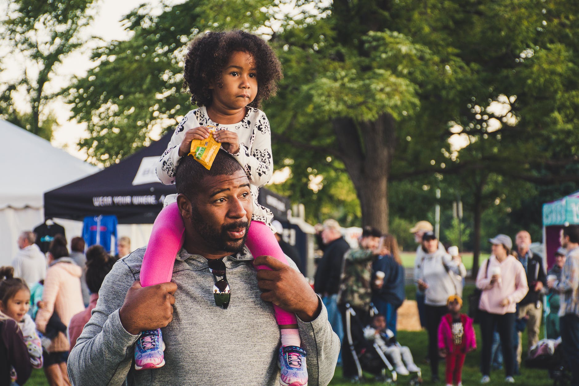 man carrying girl on shoulder